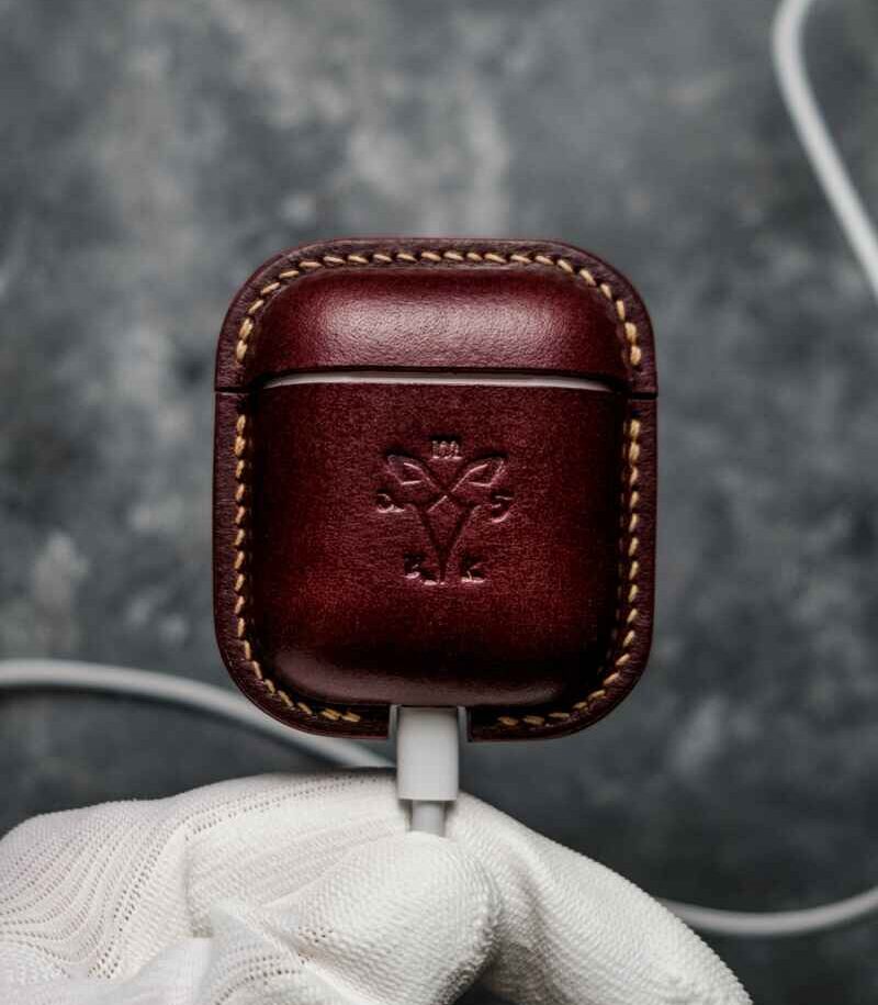 Husă AirPods 2 vișiniu din piele naturală, față, logo embossat, cusătură manuală bej, capsă metalică silver, canturi vopsite